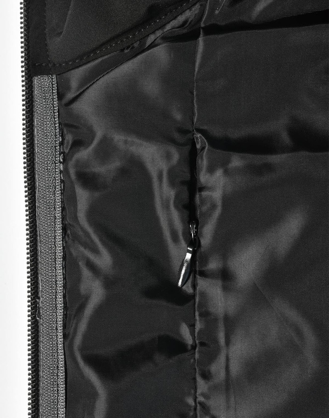 A close-up of a quilted jacket's interior lining in black, featuring a zippered pocket and smooth texture.