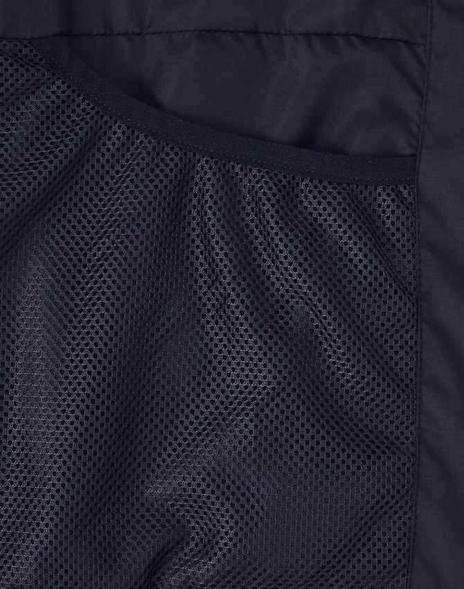 A close-up of the interior lining of a black sustainable parka jacket featuring a mesh texture.