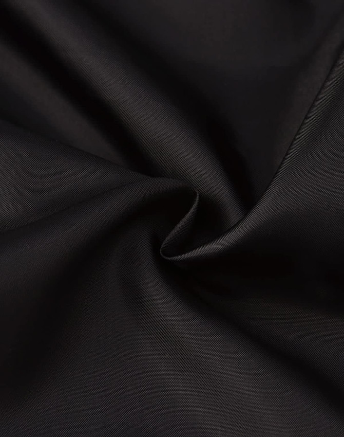 A close-up of smooth black fabric, showcasing its texture and sheen, ideal for a puffer jacket.