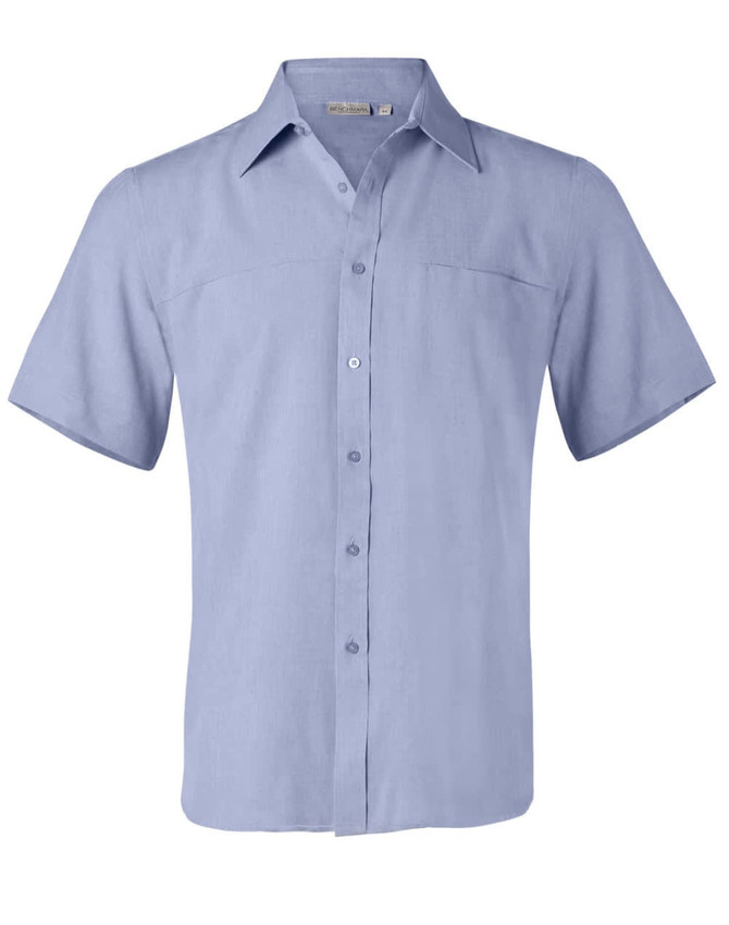 A light blue short sleeve shirt with a collar, button front, and a chest pocket, featuring a branding logo.