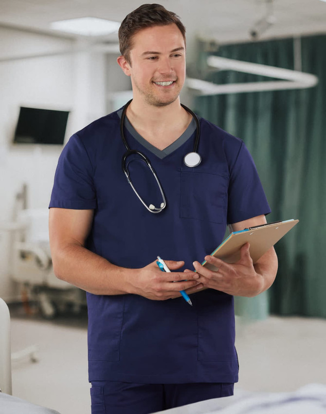 A men's short-sleeve scrub top in navy blue with a contrast colour neckline and a pocket, featuring a stethoscope.