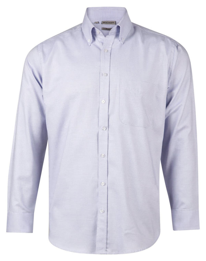 A long sleeve, button-up shirt in light blue with a pocket and a logo.