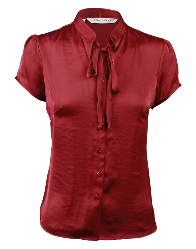 Red satin blouse with short sleeves and a tie neck detail, featuring a button-down front and a logo at the collar.