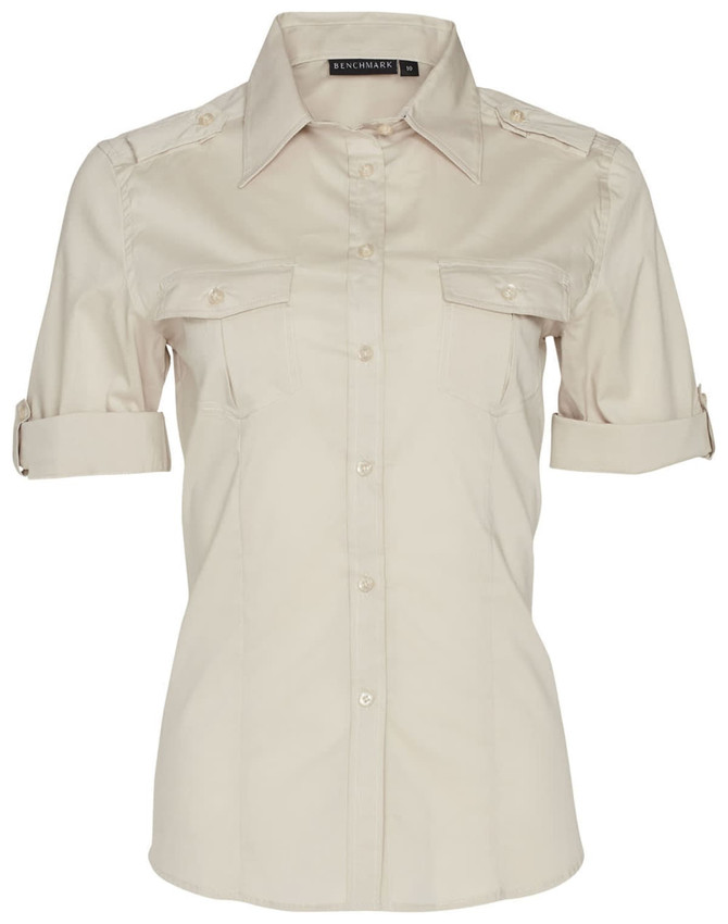 A women's short sleeve military shirt in a beige colour, featuring two front pockets and a logo on the collar.