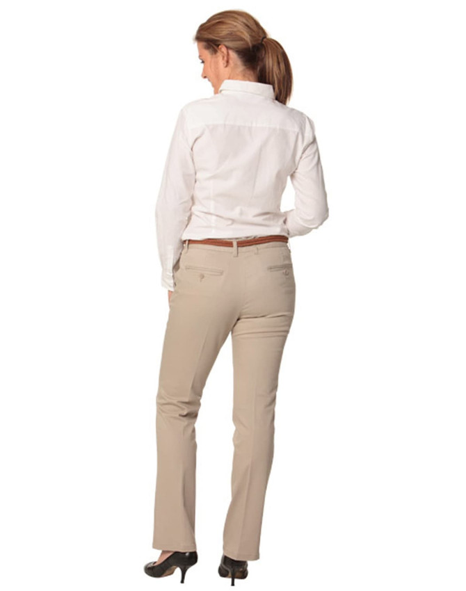 Women's chino pants in beige, featuring a straight leg design and pockets, paired with a white shirt.