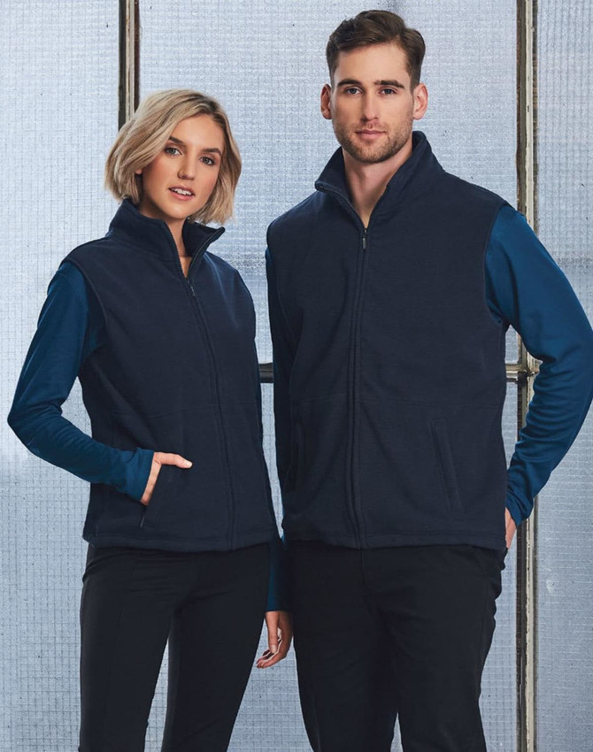 A unisex polar fleece vest in navy blue, worn by a male and female model, features a front zip and pockets.