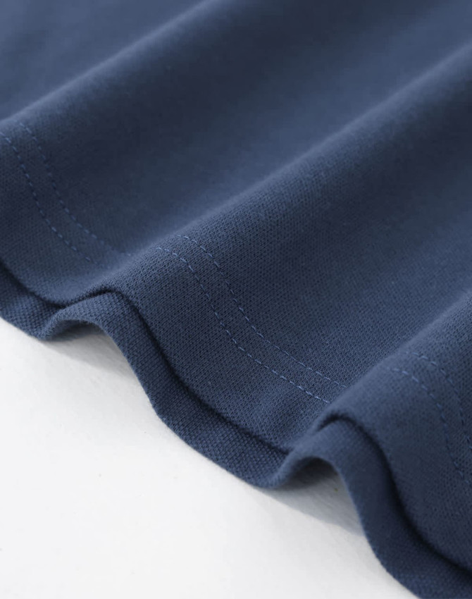 A navy cotton stretch polo shirt displayed flat, showcasing the fabric texture and stitching details.