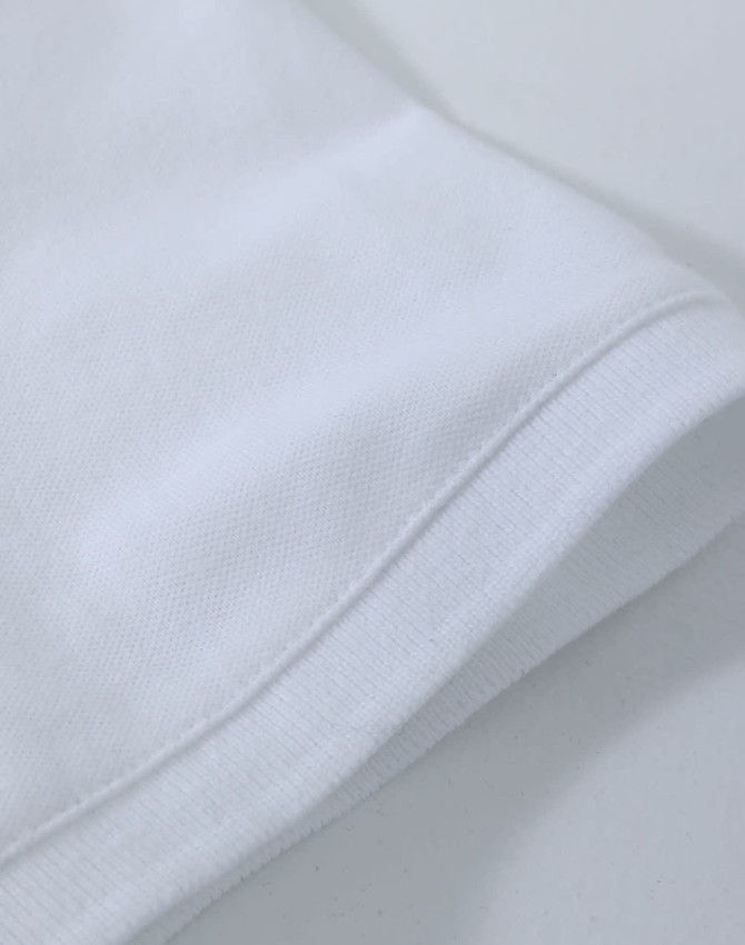 A white ladies cotton stretch polo shirt, featuring a classic collar and short sleeves, with a logo present.