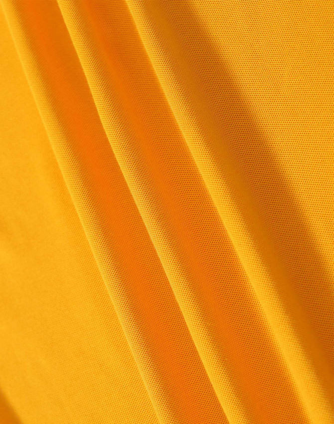 A close-up of yellow fabric featuring a textured weave, showcasing its smooth and soft surface.