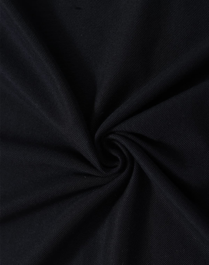 A close-up of black fabric in a swirling pattern, showcasing the texture and weave of the material.