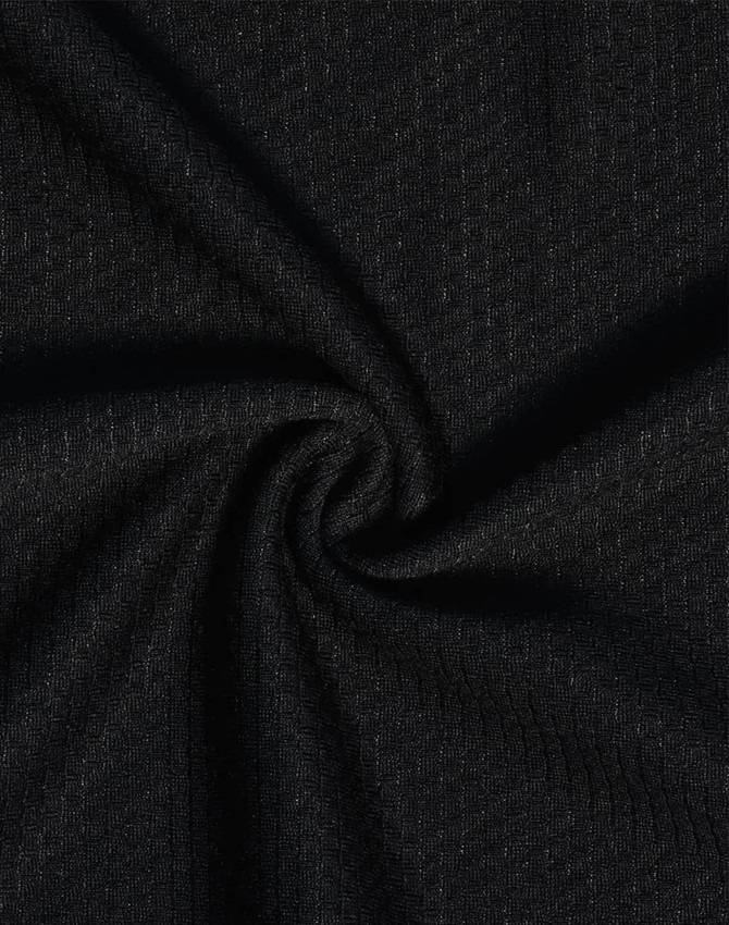 A close-up view of black textured fabric, showcasing a woven pattern suitable for polo shirts.