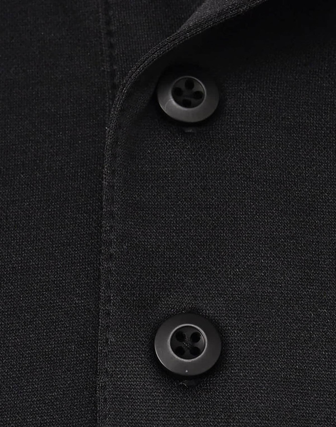 A close-up of a black polo shirt featuring two black buttons and a collar. It has a logo on the fabric.