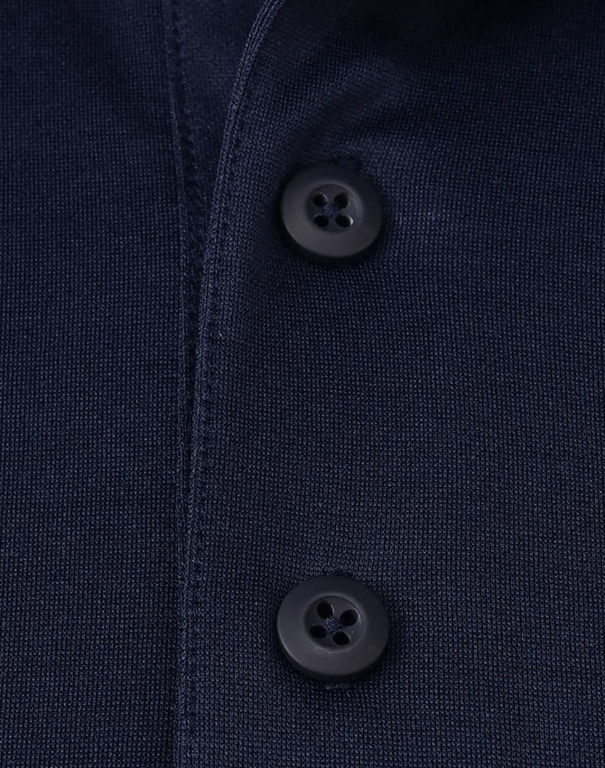 A navy blue polo shirt featuring black buttons and a clean, textured fabric. It has a logo on the garment.