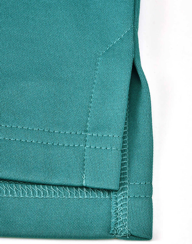A close-up of a teal men's sustainable poly/cotton polo shirt, featuring a detailed hem and stitching.