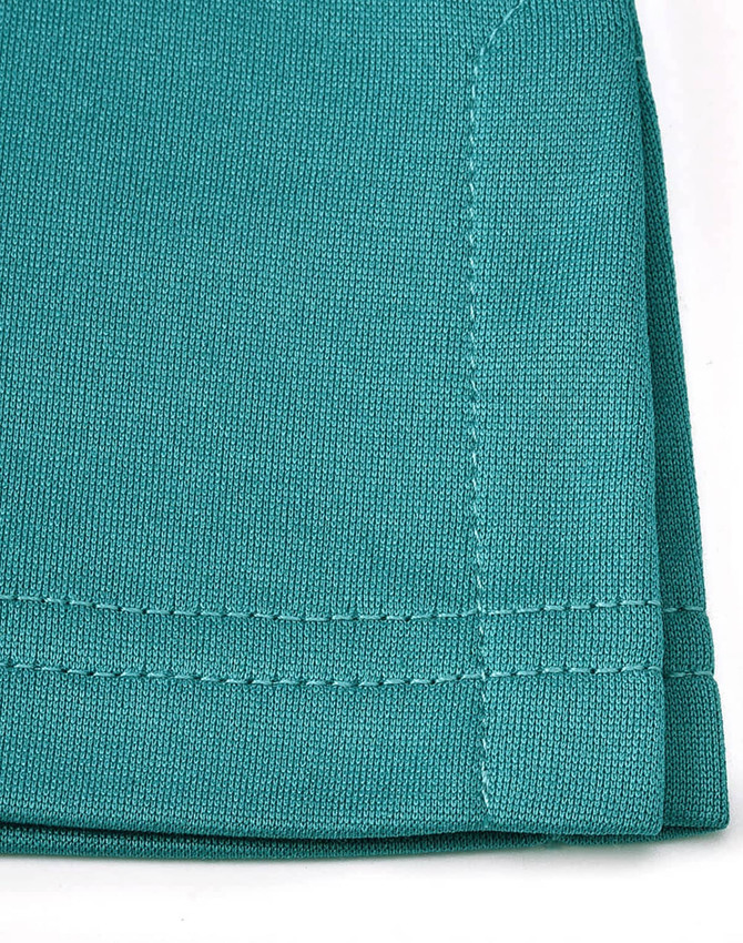 A close-up of a teal sustainable poly/cotton polo shirt showing the fabric texture and stitching details.