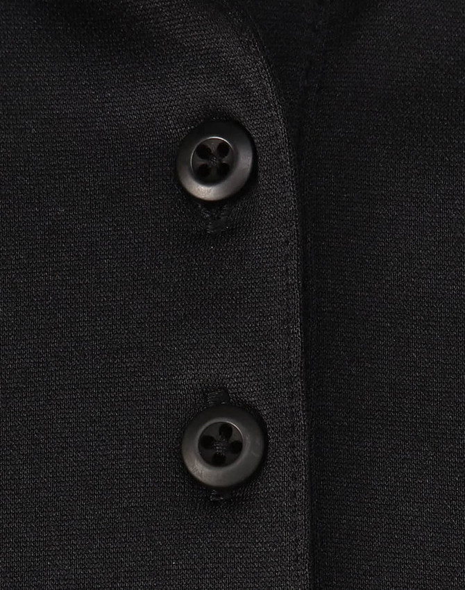 A close-up of a black polo shirt featuring buttons and a subtle texture, highlighting its sustainable fabric.