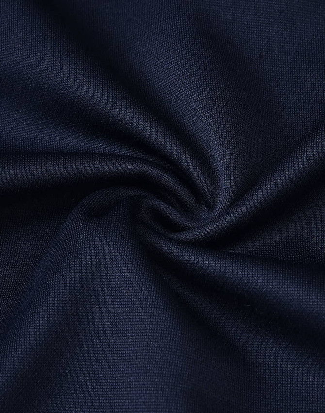 A close-up of navy blue fabric with a smooth texture, highlighting its softness and durability.