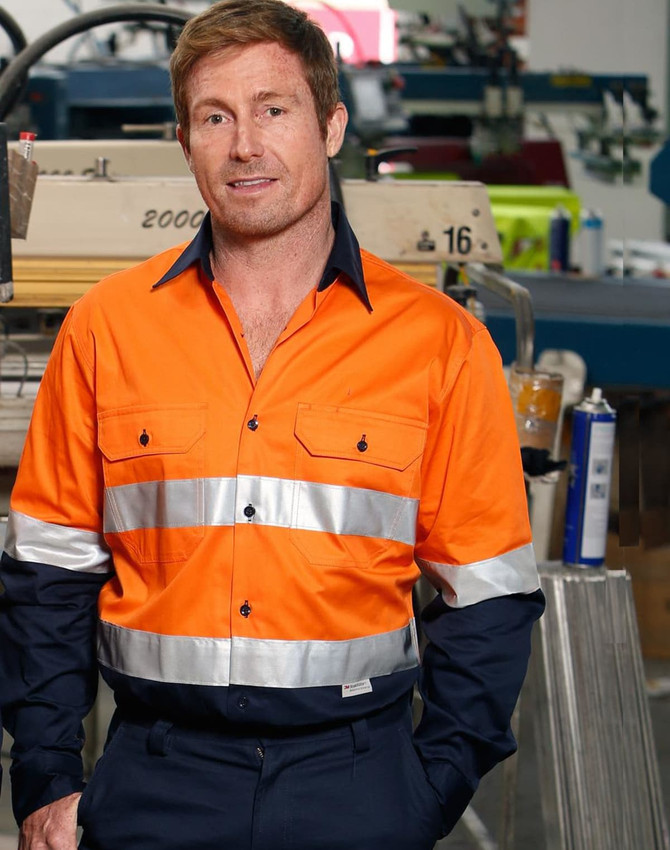 Men's long-sleeve safety shirt in hi-vis orange with reflective tape, featuring a black collar, and a logo.