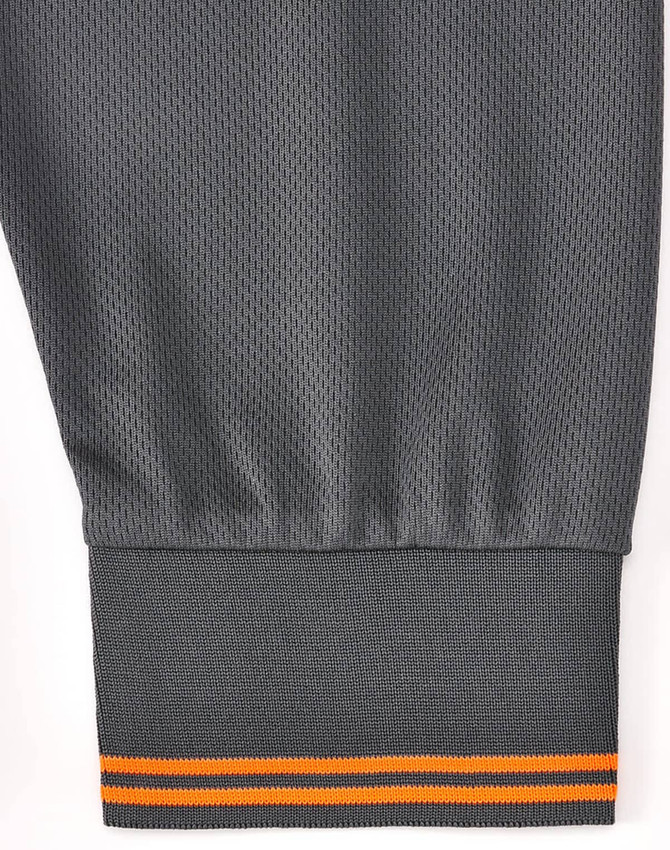A grey long-sleeve polo shirt featuring segmented detailing with an orange stripe at the cuff. It has a logo on the garment.