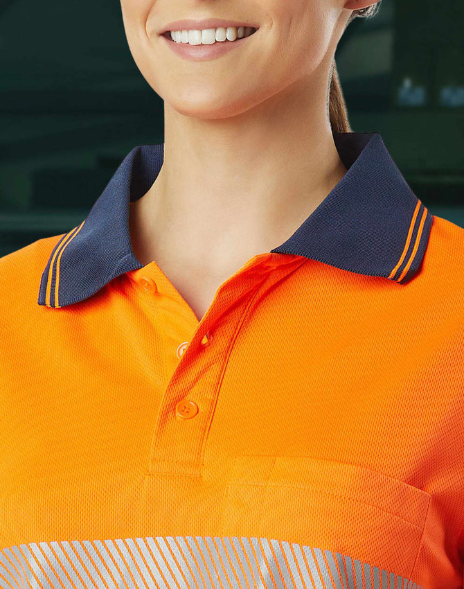 Unisex Cooldry segmented safety long sleeve polo in bright orange with navy collar and a pocket. Features a logo.