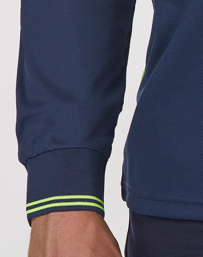 A close-up of a navy unisex polo shirt featuring segmented long sleeves and contrast stitching in green.