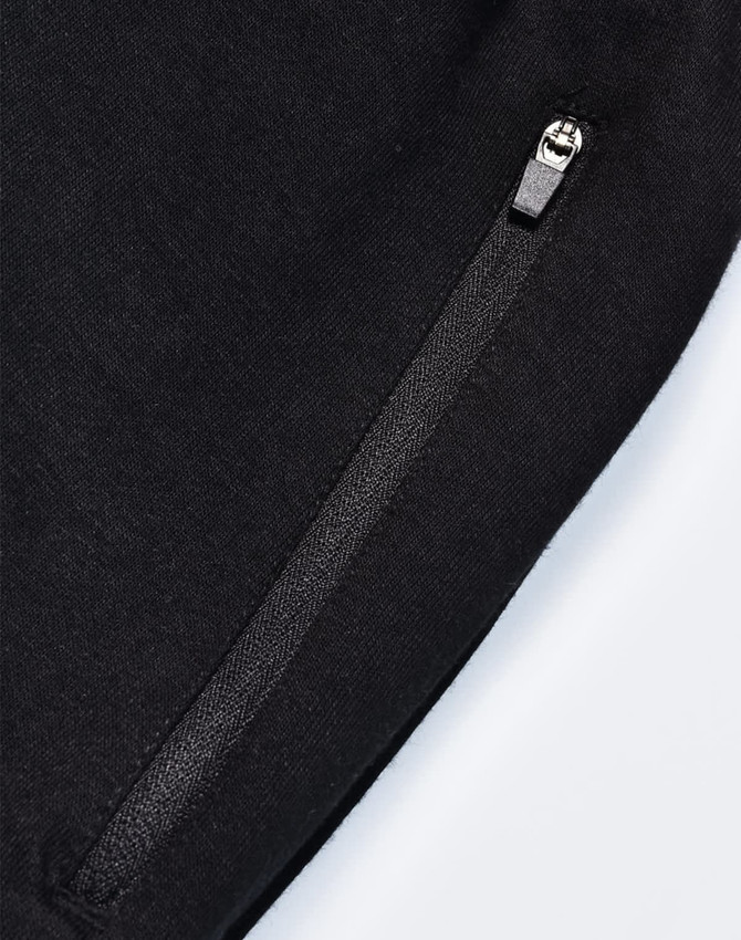 A pair of black poly/cotton terry sweat pants featuring a zip pocket and a soft texture.