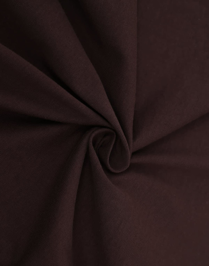 A close-up of brown fabric, showcasing a smooth, premium cotton texture suitable for making t-shirts.