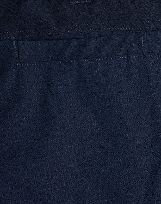 Navy rip-stop poly/cotton stretch work pants with a smooth fabric texture and a branding logo.