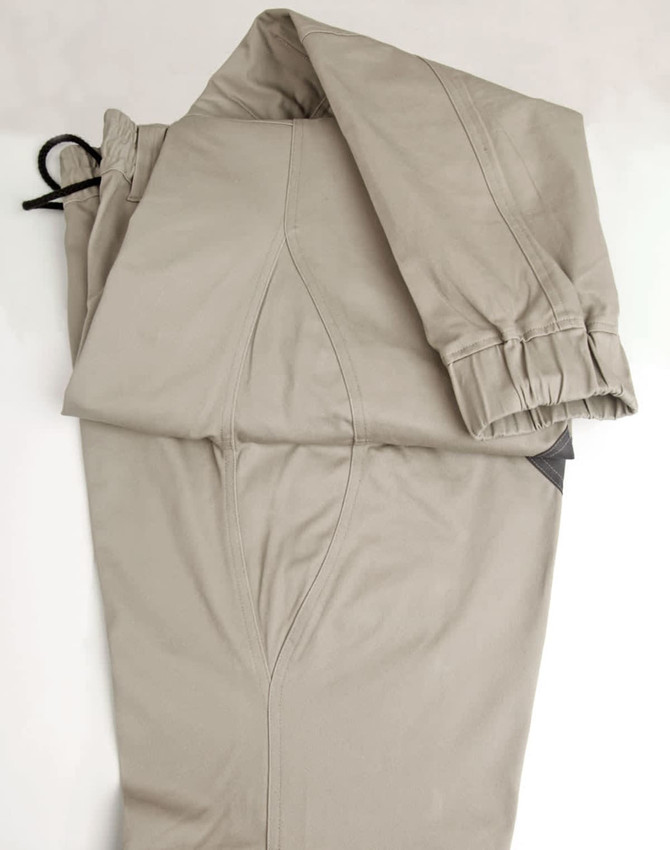 Unisex cotton stretch drill cuffed work pants in a light beige colour, featuring a cuffed design and a drawstring.