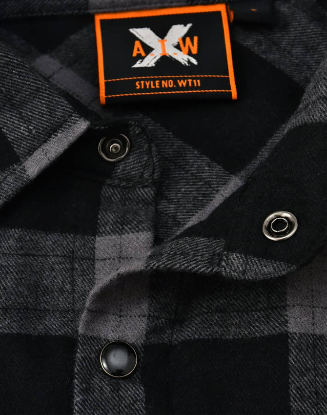A black and grey plaid unisex flannel button-up shirt featuring snap buttons and a logo tag.