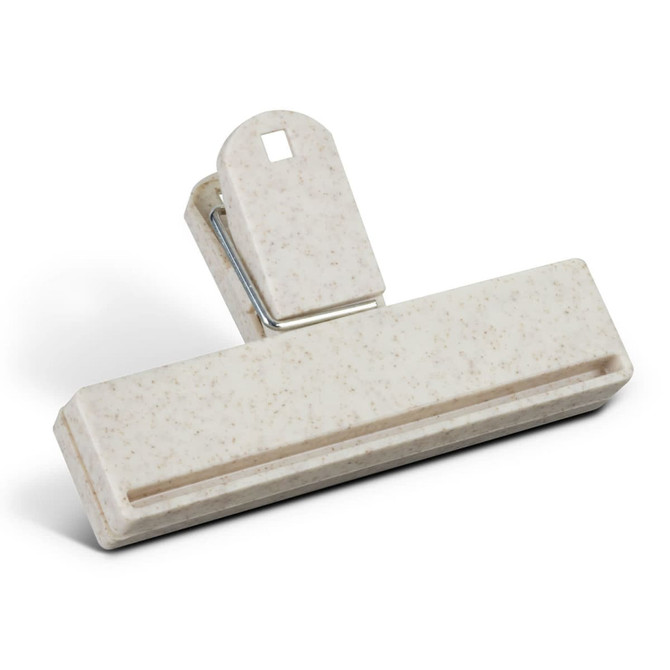 A beige snack bag clip with a textured surface and a silver metal spring mechanism.