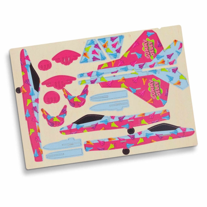 A wooden model kit of a jet fighter featuring vibrant pink, blue, and multicoloured designs, with various parts included.
