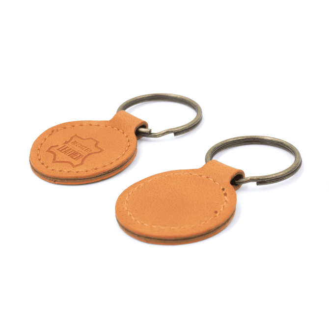A tan recycled leather keyring with a metal keychain, featuring a branded logo on one side.
