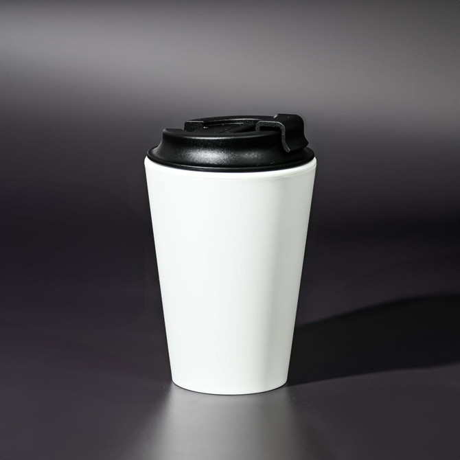 A coffee mug made from recycled PP, featuring a white body and a black lid. It has a logo on the side.