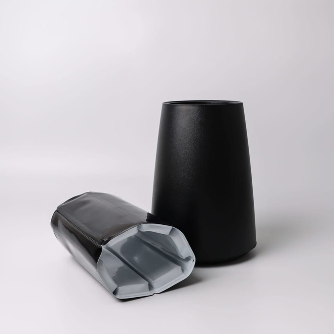 A black Catalina Wine Cooler with a sleek design and a glossy base. It features a logo on its surface.
