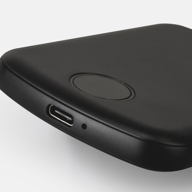 A black wireless charging power bank with a USB-C port and a branding logo.