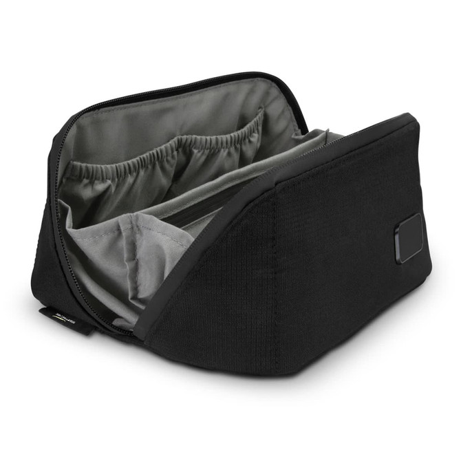 A black toiletry bag with a spacious interior and organisational pockets, featuring a sleek design.