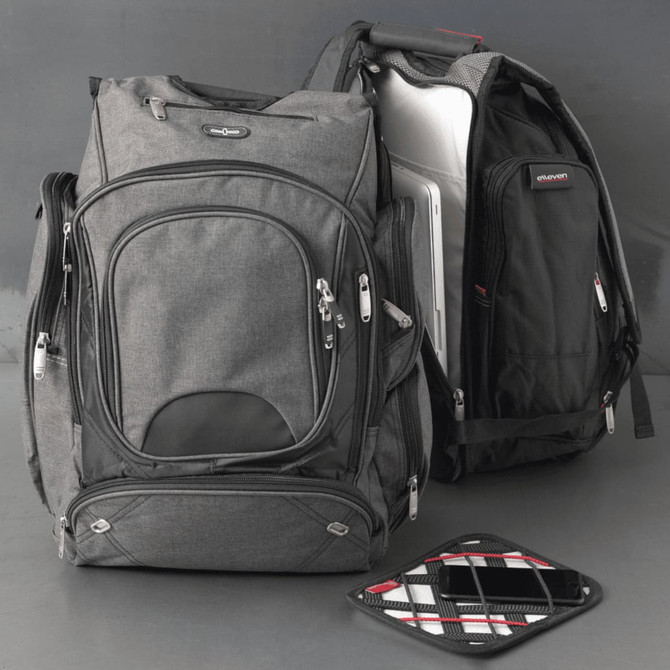A black and grey checkpoint-friendly backpack with compartments, featuring a sleek design and a logo.
