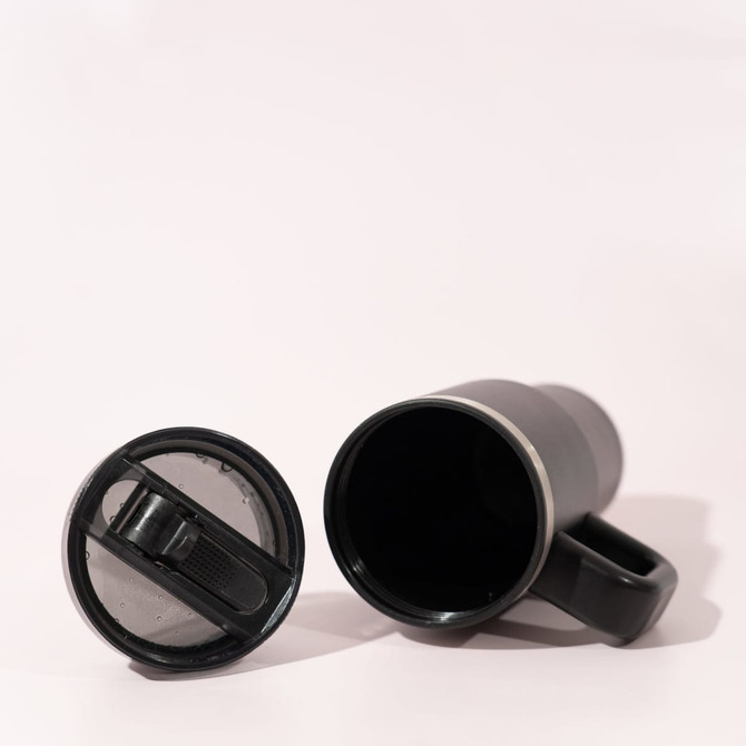 A double wall mug in black with a detachable lid, featuring a handle and a sleek design.