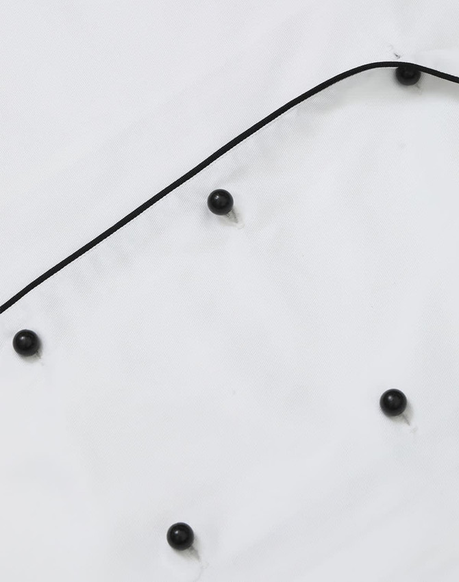 A unisex executive chef jacket in white with black buttons and piping detail. It features a classic design.