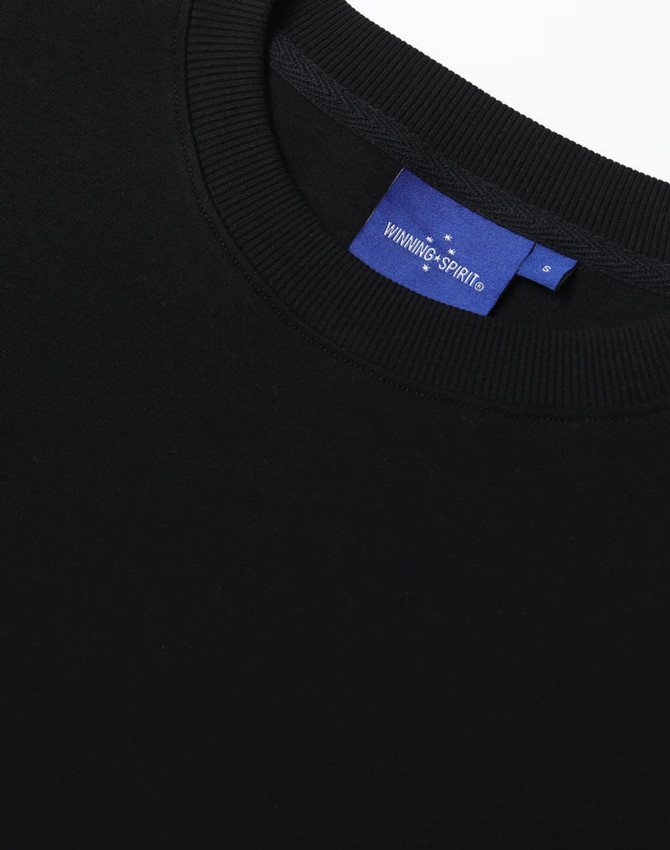 A black unisex crew neck sweater with a ribbed neckline and a branding label.