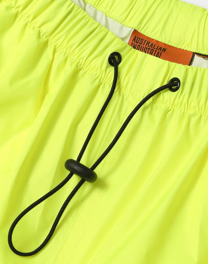 Bright yellow lightweight nylon waterproof rain pants with an adjustable drawstring waistband and branding tag.
