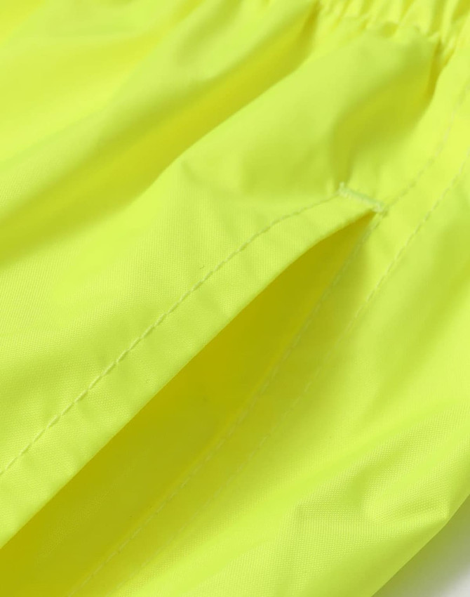 Bright yellow waterproof rain pants with an elastic waistband and side pockets. Featuring a smooth nylon texture.