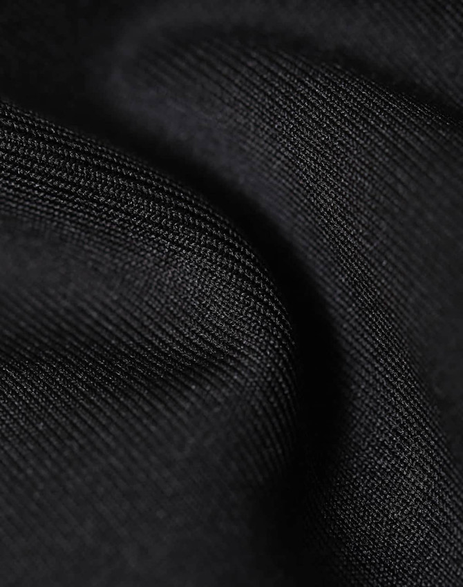 A close-up of black fabric, showing a soft, textured surface with fine details. The material appears sustainable and durable.