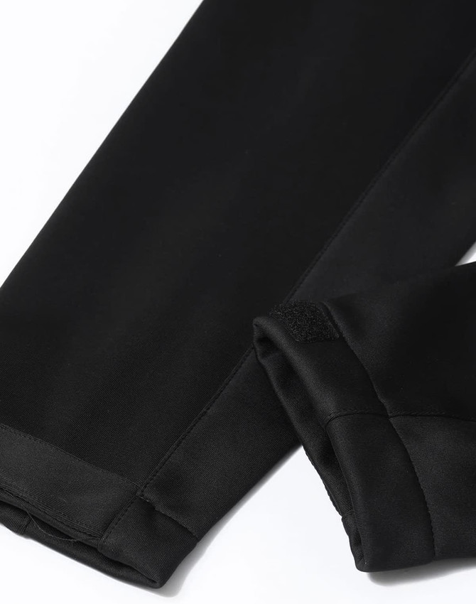 A black sustainable softshell corporate jacket featuring sleek, smooth fabric and a stylish design.