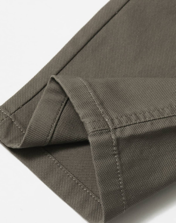 A close-up of the hem of khaki ladies' flexi chino pants, featuring a clean finish and tailored stitching.