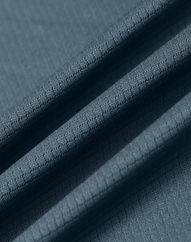 A close-up of a textured, sustainable jacquard knit fabric in a slate blue colour.