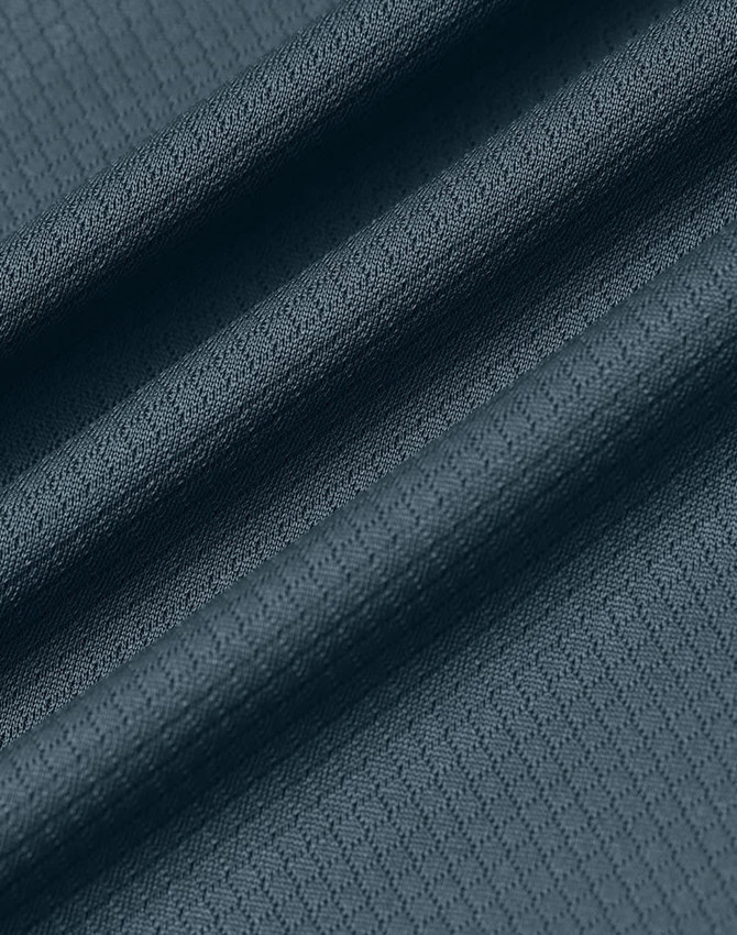 A textured fabric in a deep teal shade, featuring a jacquard knit pattern. It has a smooth finish and drapes softly.