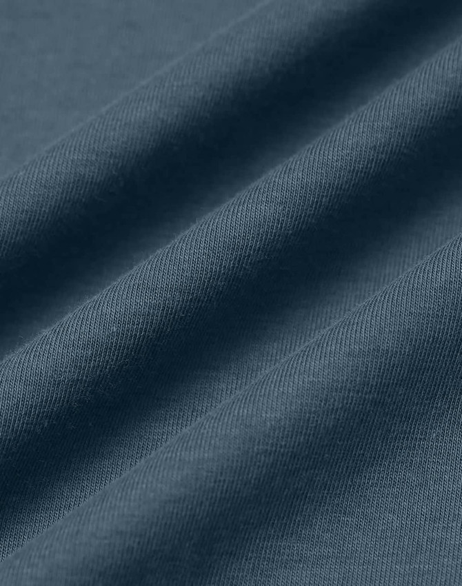 A close-up of a textured fabric in a soft, dark blue shade, showcasing the quality of cotton material.