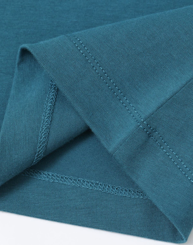 A teal ladies' premium cotton tee shirt, featuring a soft fabric and detailed stitching at the hems.